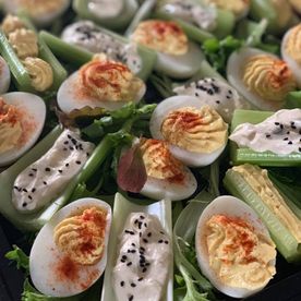 buffet food, devilled eggs and stuffed celery