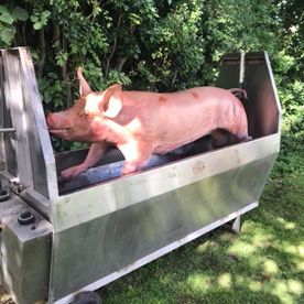 free range pig from our farm in a mobile oven for an outdoor hog roast
